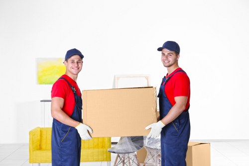 Moving team loading boxes and furniture into a van
