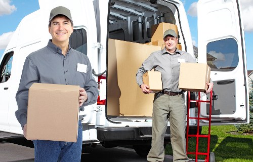 Professional movers handling desks and equipment in a Marylebone building